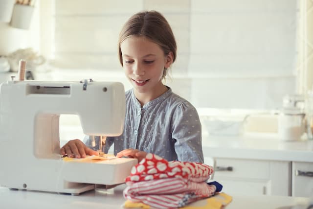 basic life skills for kids- a girl sewing