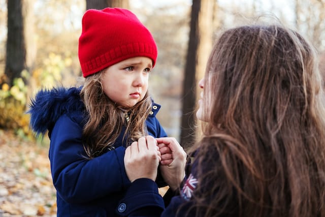 Girl sad comforted by mother- how to teach your child to be independent