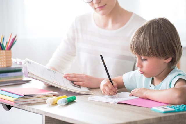 child studying with mom- how to teach your child to be independent