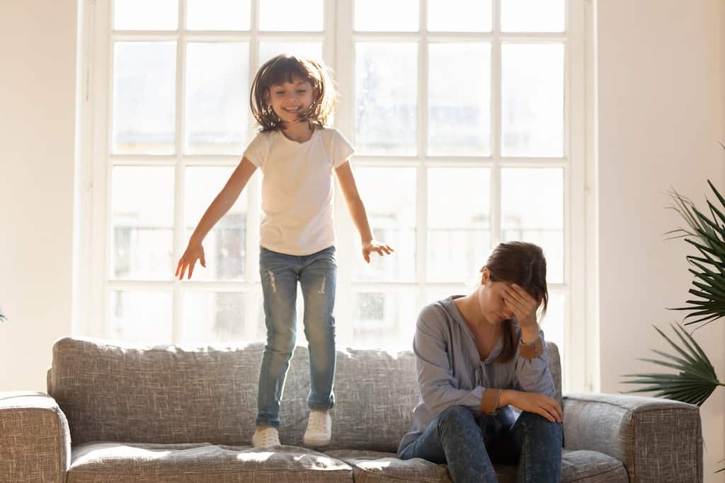 girl jumping on sofa tired mom - how to stop yelling at kids