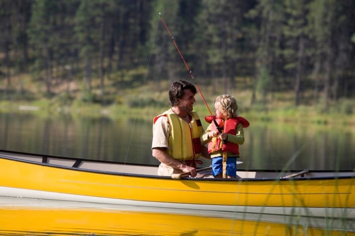 Dad speaking positively to child while fishing