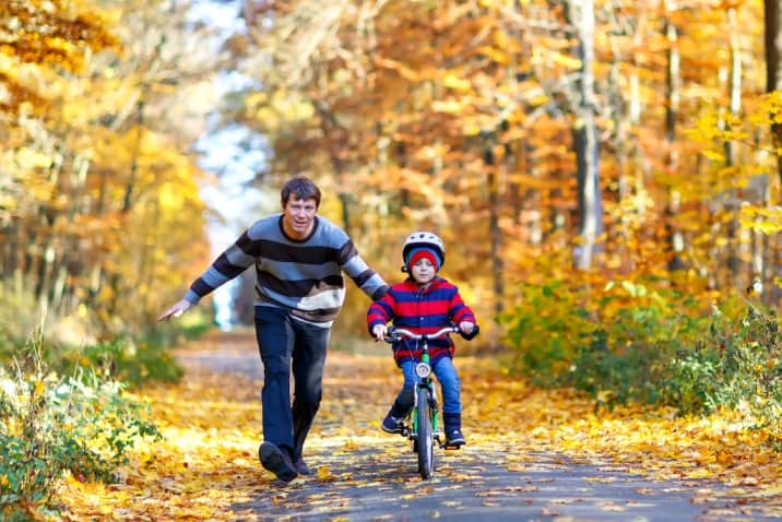 Dad training son to bike