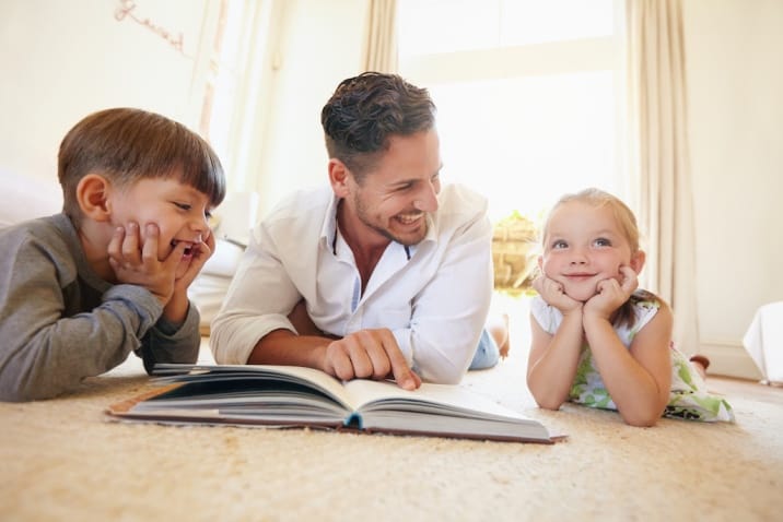 A father reading to children and using quality time to connect with them