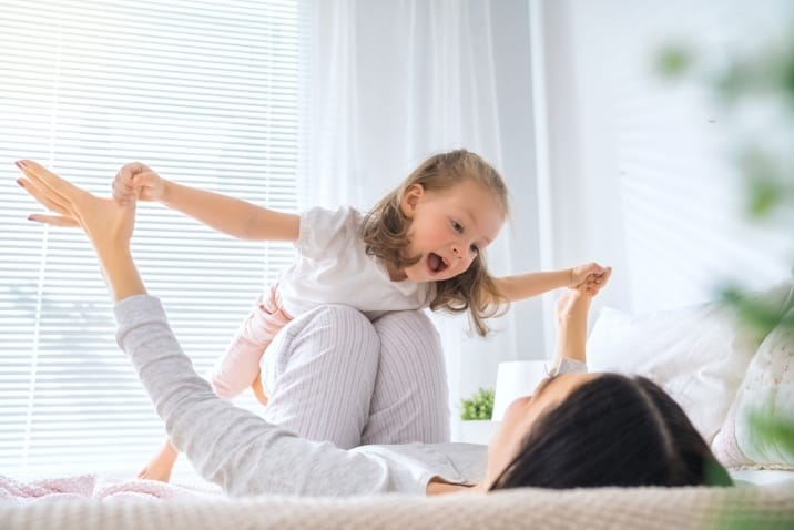 Mom playing with her daughter in the morning