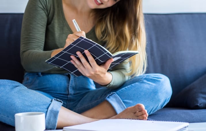 Mom writing in a journal planning her day