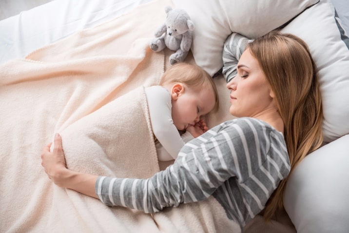 Organised mom sleeping on time with baby