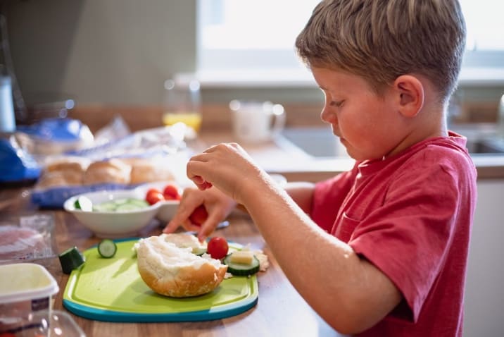 a boy making his own food