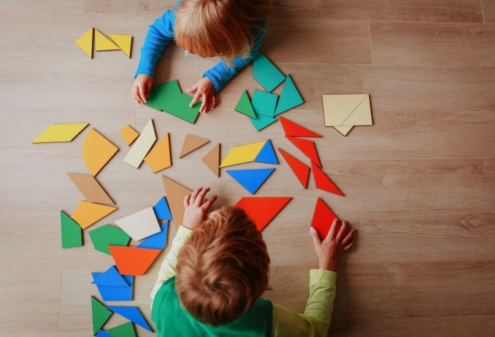 two boys solving a puzzle