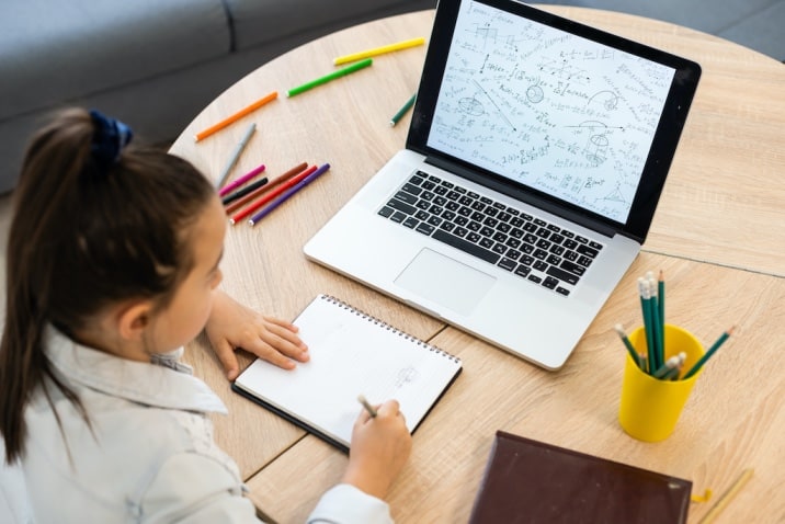 a girl studying looking at a laptop