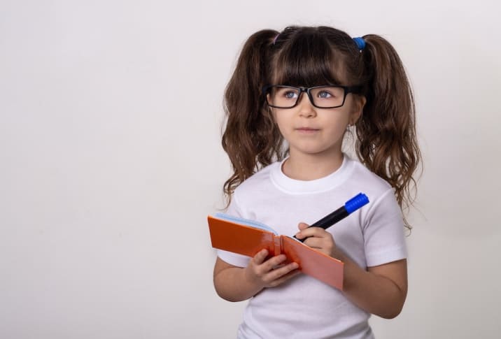 a girl writing on a notepad