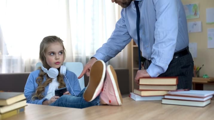 a girl listening to music and father scolding her-list of basic good manners for kids