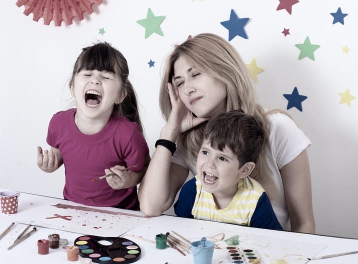 A burned out mom sitting with kids