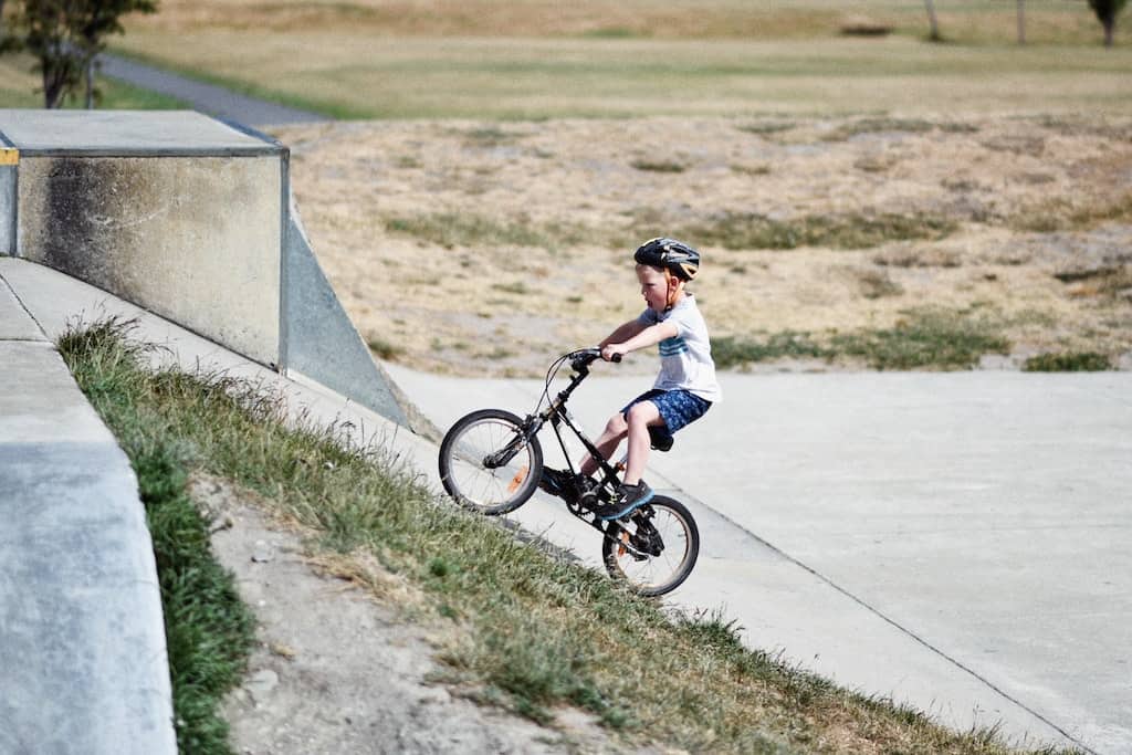 a child riding a bike up a slanted space