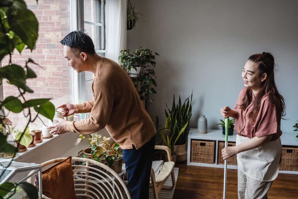 A husband and wife doing chores at homes