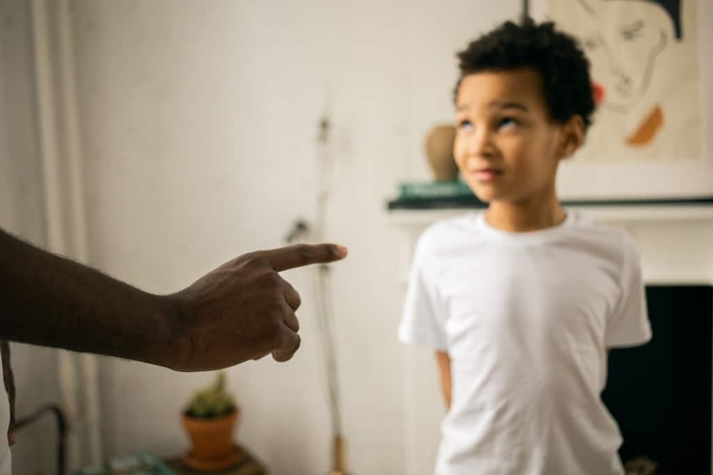 a boy being scolded 