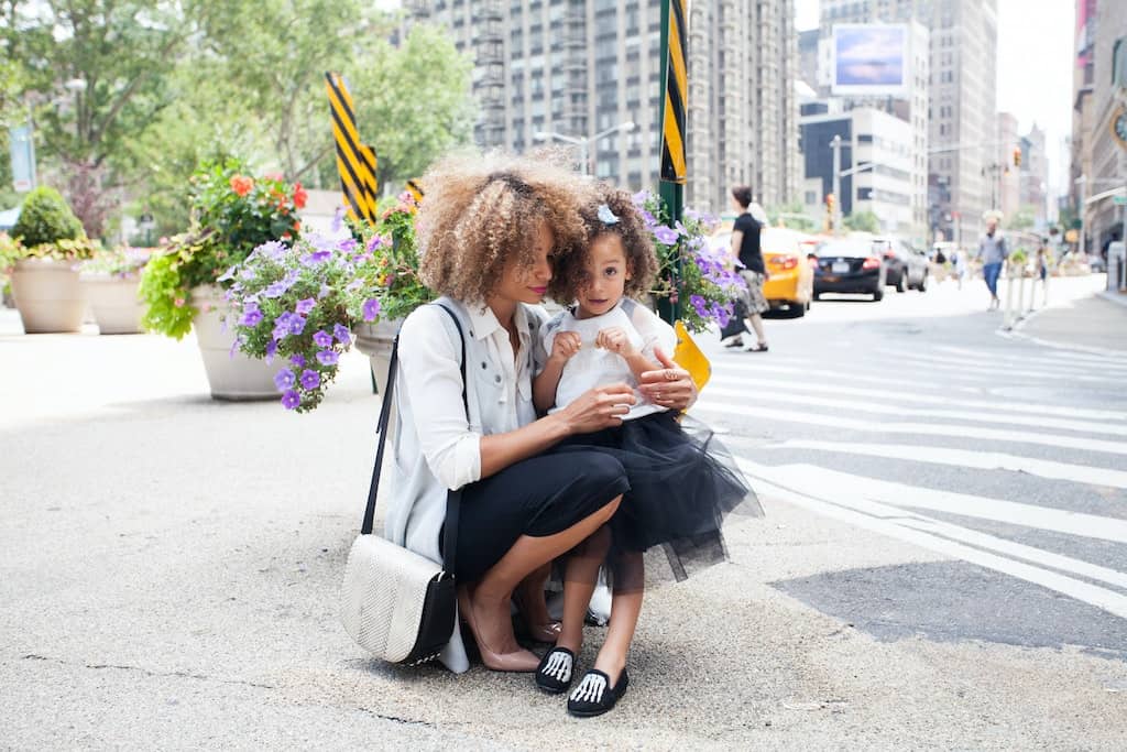 a girl hugged by her mom in the streets (how to parent a sensitive child)