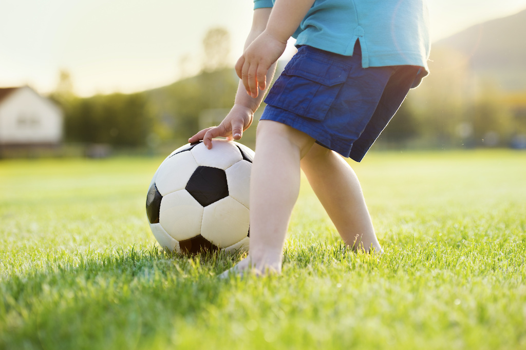 Boy playing soccer-how to develop intrinsic motivation in kids-child led interest