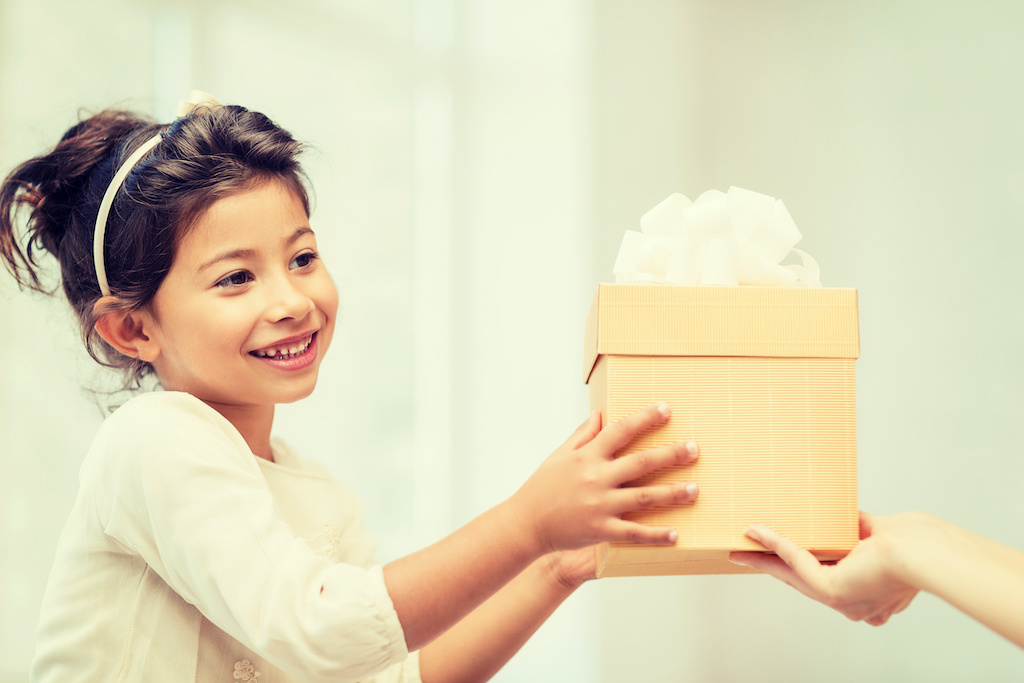 Girl receiving a gift-how to develop intrinsic motivation in kids-give extrinsic rewards when necessary