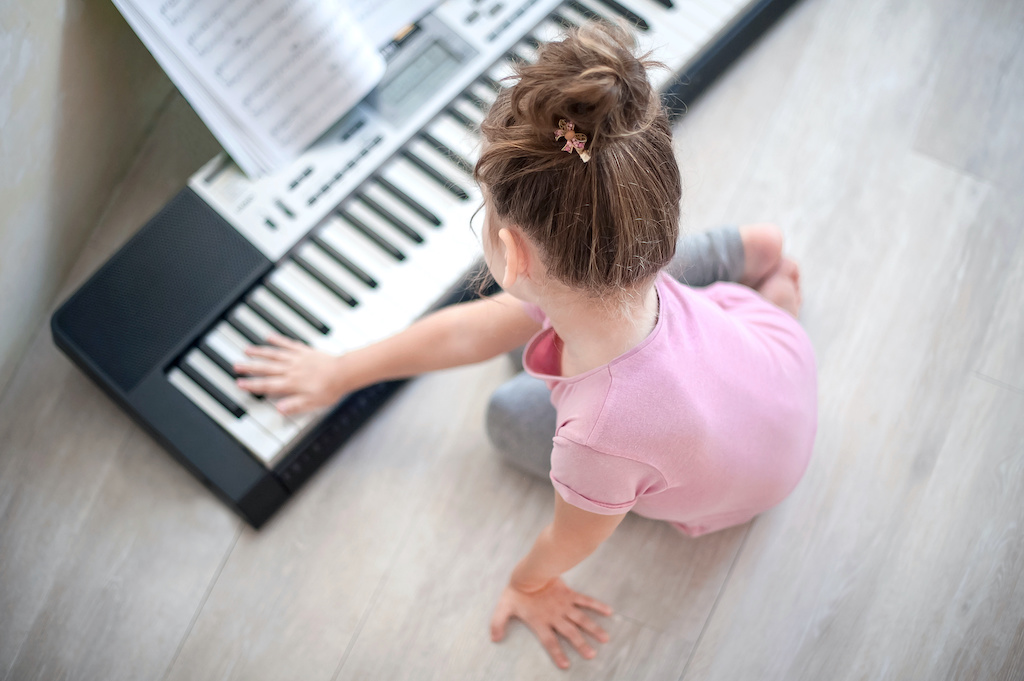 Girl playing piano-how to develop intrinsic motivation in kids-child led interest