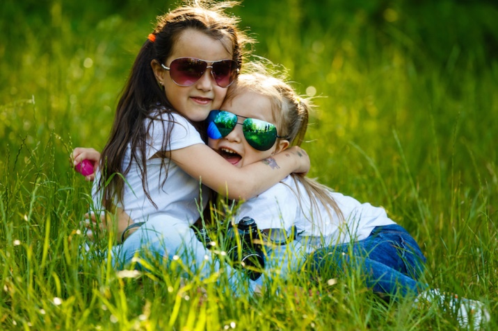 Two girls hugging each other - random acts of kindness idea