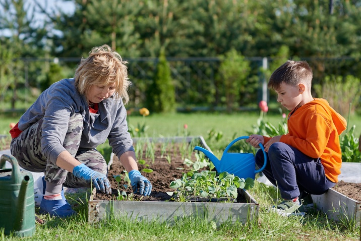 a boy helping mom with gardening- random acts of kindness idea