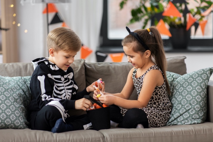 a boy and girl sharing candies