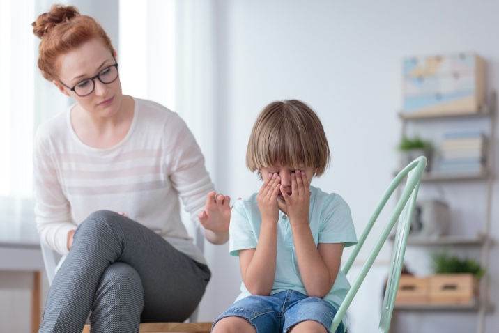 Mom trying to console a crying boy