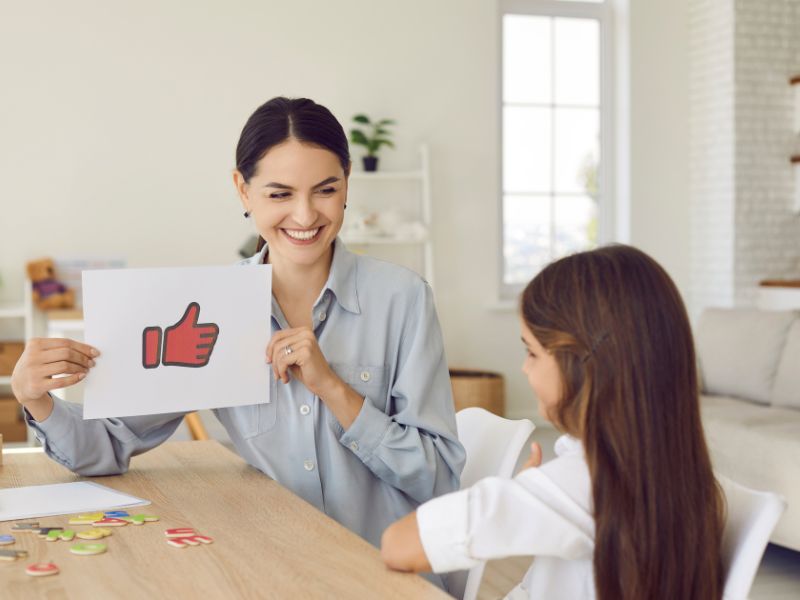 a therapist giving a positive feedback to a girl