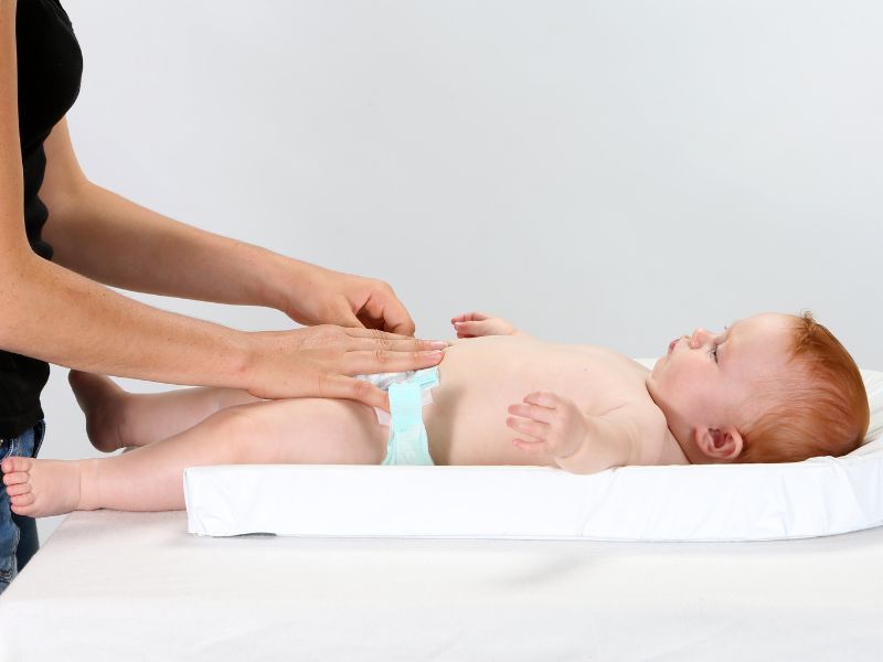 a mom changing the diaper of her baby