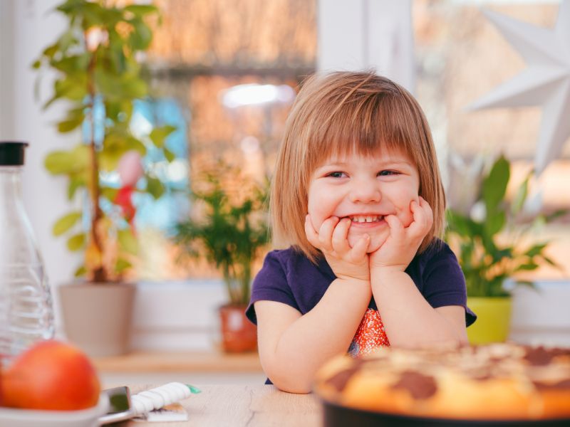 a toddler girl smiling
