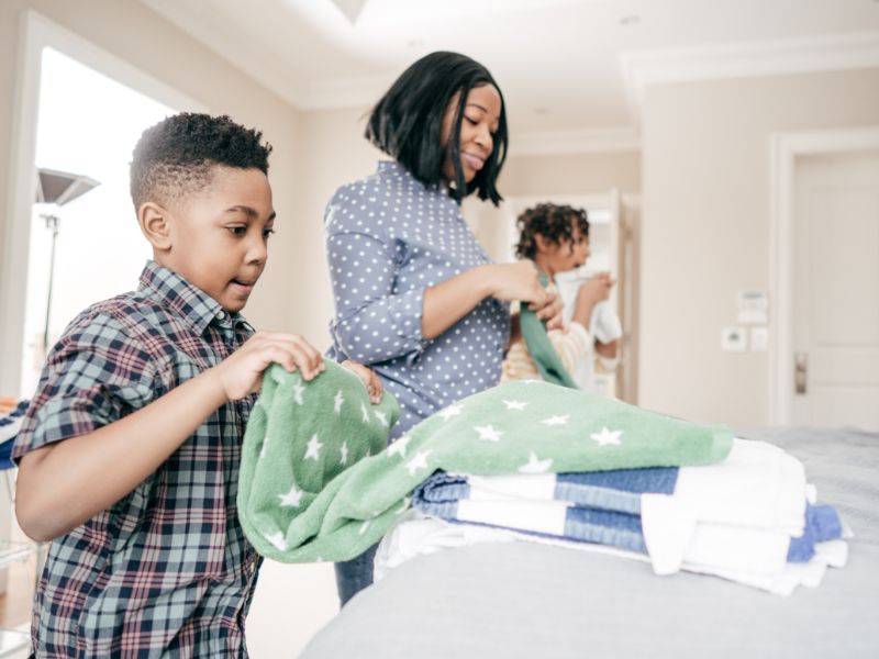 a mom and two kids doing chores together