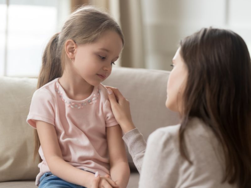 mom talking to a daughter who looks sad