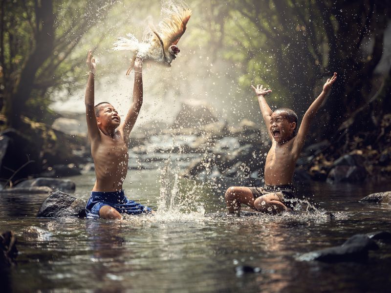 kids splashing water in a forest environment-nature play for kids