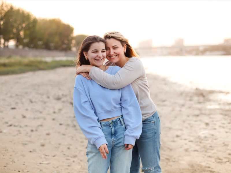 Mother and teen daughter at a beach spending quality time together