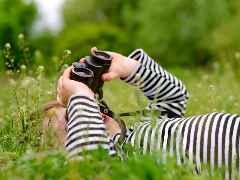 kid looking through a binocular-nature play for kids