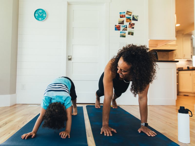 a mom doing exercise with her child-Doing exercise can help moms overcome tiredness