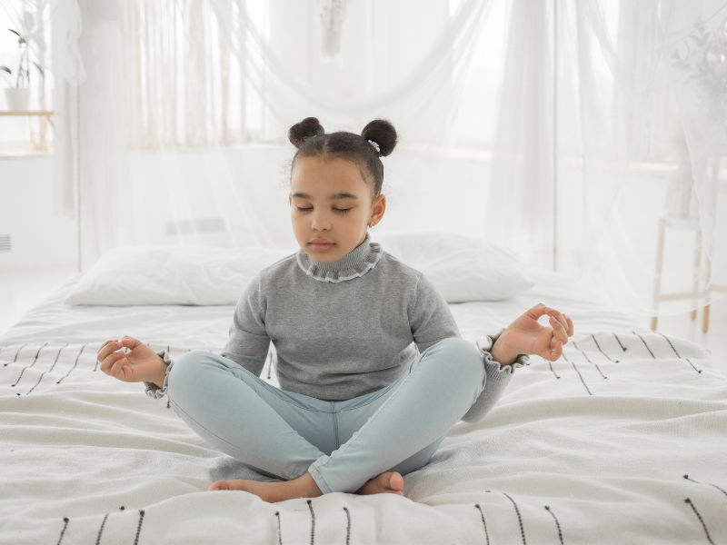 a child meditating - establishing a bedtime routine for kids