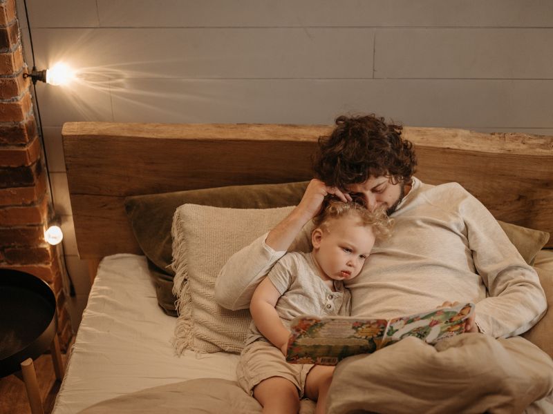 a father reading a bedtime story to baby - establishing a bedtime routine for kids