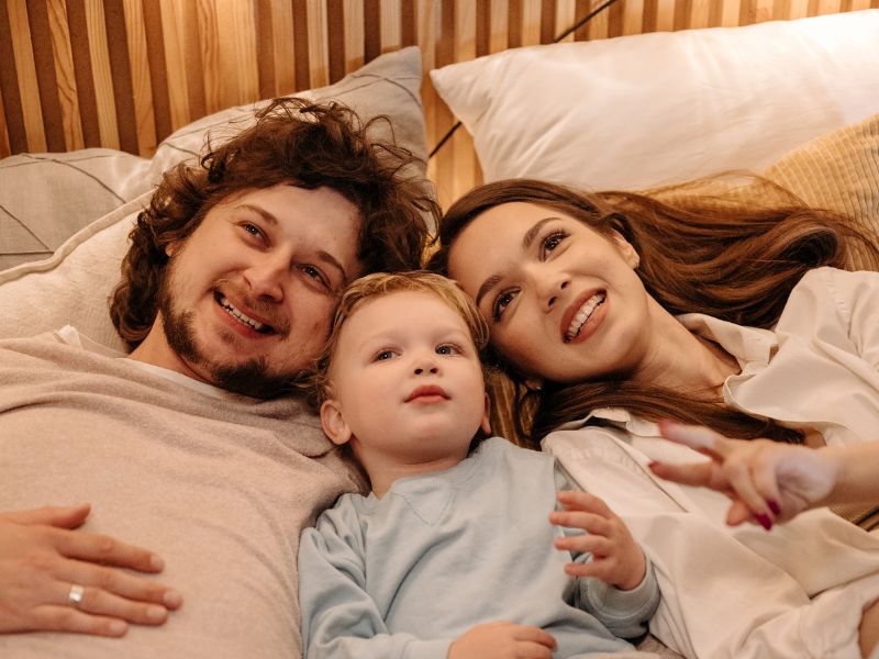 a mom and dad talking with son before sleep - calm down activities for kids to wind down before sleep